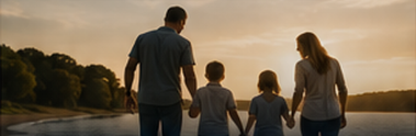 Family walking beside a lake